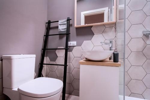 a bathroom with a white toilet and a sink at Romantic and spacious apartment in Riga Old Town in Rīga