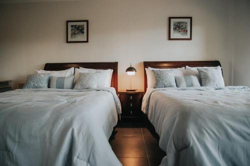 two beds sitting next to each other in a bedroom at 150 Peakway Mountain Resort in Dalaguete