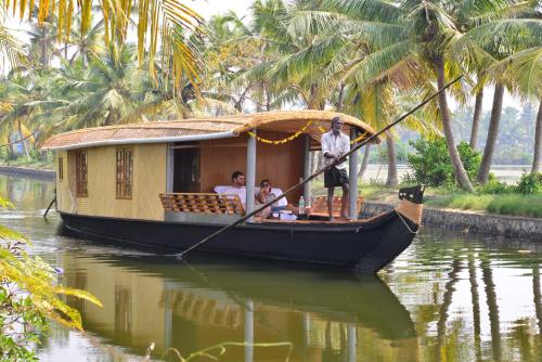 a group of people on a boat in the water at Breeze Backwater Homes in Cochin
