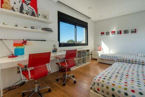 a bedroom with two red chairs and a bed at M4R Architect House Llubi in Llubí