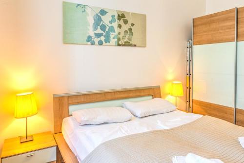 a bedroom with two beds and two lamps in it at Budapest City Center Apartments in Budapest