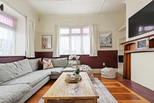 a living room with a couch and a coffee table at The Bungalow in Hamilton