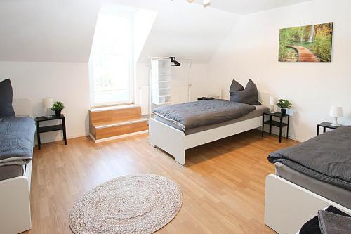 a bedroom with two beds and a window at Spacious Apartment with Balcony & WiFi in Wetzlar