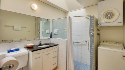 a bathroom with a toilet sink and a shower at Executive Hideaway in Benalla