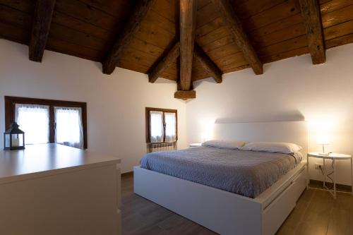 a bedroom with a bed in a room with wooden ceilings at My home in Venice in Mestre