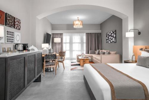a hotel room with a bed and a living room at Steigenberger Golf Resort El Gouna in Hurghada