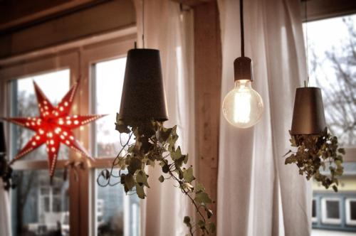 a group of three lights and a star on a window at EASY Lodges Berlin in Berlin