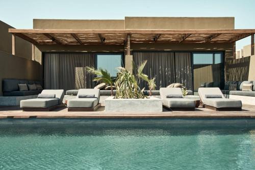 - un groupe de chaises longues et une piscine dans l'établissement Casa Cook El Gouna - Adults Only, à Hurghada