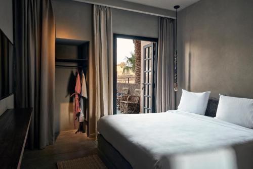 um quarto de hotel com uma cama e uma janela em Cook’s Club El Gouna (Adults Only) em Hurghada