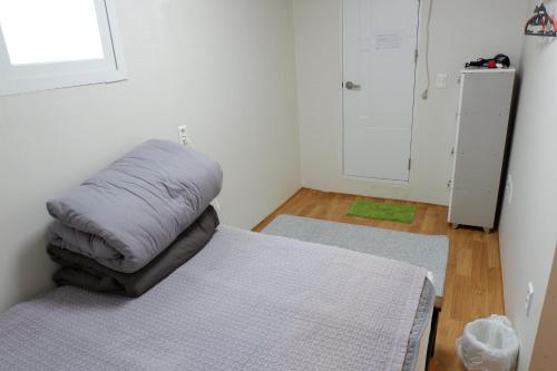 a bedroom with a bed with a pillow on it at Haru The Guesthouse in Andong