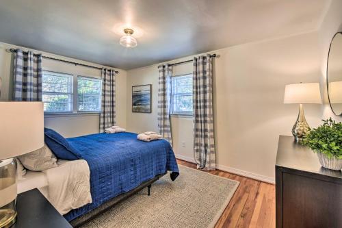 a bedroom with a blue bed and two windows at Stunning Seneca Home with Lake Keowee Access! in Seneca