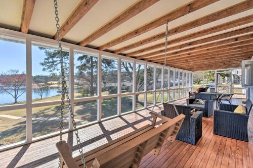 a porch with swings and a view of the water at Stunning Seneca Home with Lake Keowee Access! in Seneca