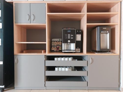 a kitchen with two microwaves and a microwave at CVJM Freizeithaus MS Waterdelle in Borkum