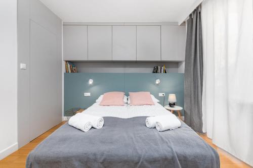 a bedroom with a large bed with two pillows at Hoża 36 by Homeprime in Warsaw