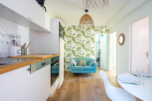 - une cuisine avec un canapé bleu dans une chambre dans l'établissement Maison Giribaldi, à Nice