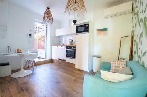 un salon avec un canapé bleu et une table dans l'établissement Maison Giribaldi, à Nice