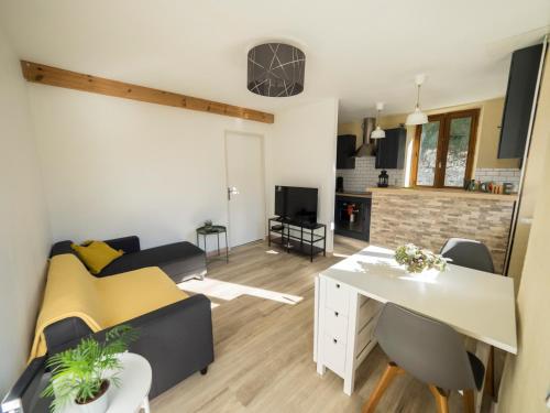 a living room with a bed and a dining room at Charmant T2 in Aix-les-Bains