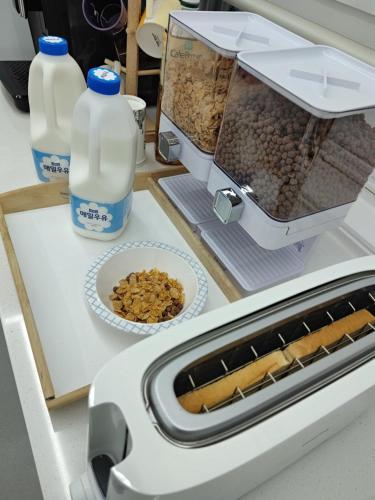 a toaster sitting on a counter with food and milk at Athene Motel in Gwangju