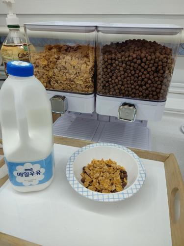 a refrigerator with a bottle of milk and a bowl of nuts at Athene Motel in Gwangju