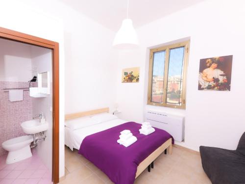 a bedroom with a bed and a toilet and a mirror at Cielo Vaticano Guest House in Rome