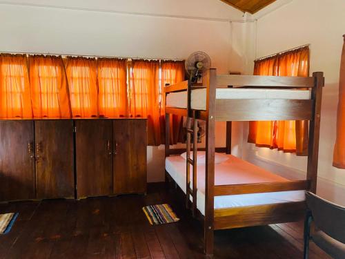 a room with two bunk beds and wooden cabinets at Tanty’s Hostel in Galle