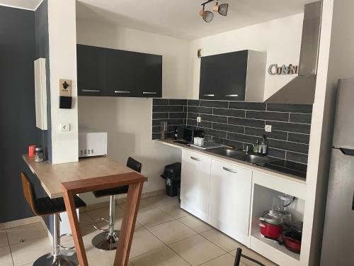a small kitchen with a sink and a counter at Appartement t3 rdc in Saint-Denis
