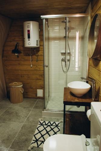 a bathroom with a shower and a sink at World Peaks Hotel in Richka