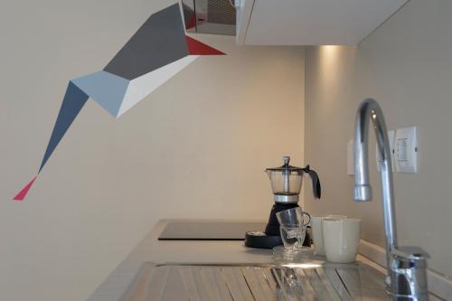 a kitchen counter with a blender on a counter top at Everyday Apartments Corte Petroni in Bologna