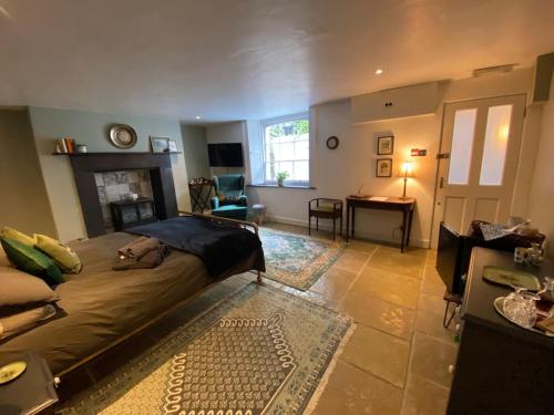 a bedroom with a large bed and a living room at Clifton Georgian Townhouse, Inviting Ensuite Room & Plant Based Breakfast in Bristol