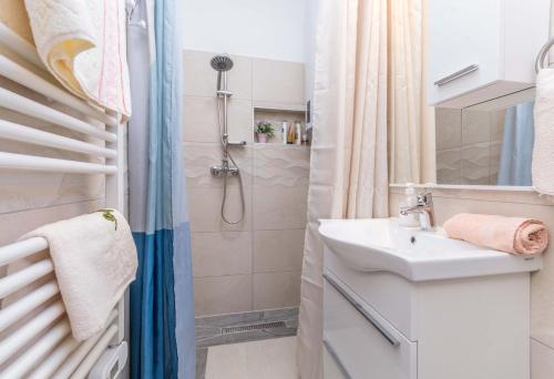 a small bathroom with a sink and a shower at Savić Biograd in Biograd na Moru