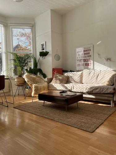 a living room with a couch and a coffee table at Gorgeous 1 bed flat near Richmond Bridge. in Richmond