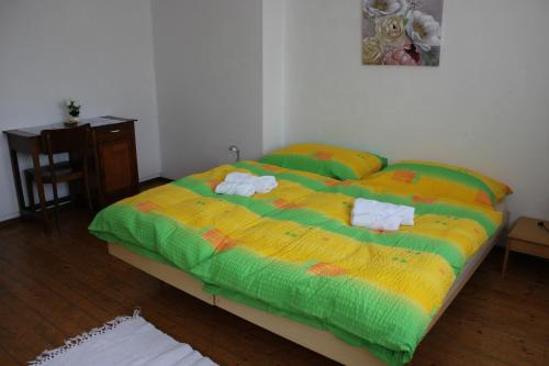 a bedroom with a bed with two towels on it at Osteria con alloggio Ul Furmighin in Morbio Inferiore