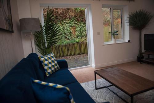 a living room with a blue couch and a table at Spacious 3 Bed House in Bristol in Bristol