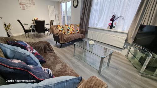 a living room with two couches and a television at Blueville House, Bluewater, 4 Bedroom Houses, Greenhithe, Dartford, Kent-Hosted by Castile Accommodations Ltd in Kent