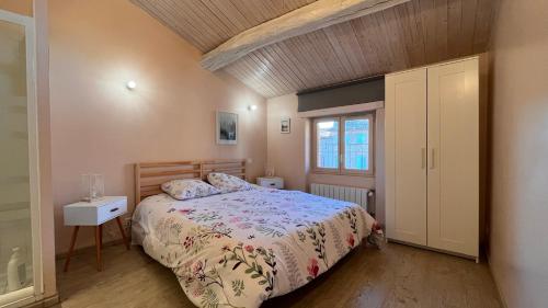 a bedroom with a bed and a window at Le Gite d Eugenie in Gaillac