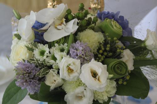 a bouquet of white and purple flowers at Valloris Apartments in Hévíz
