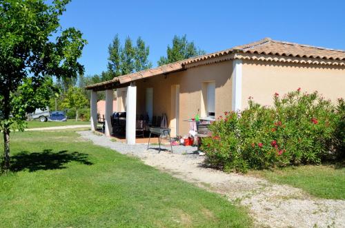 a small house with a garden in front of it at Domaine des Garrigues in Grospierres