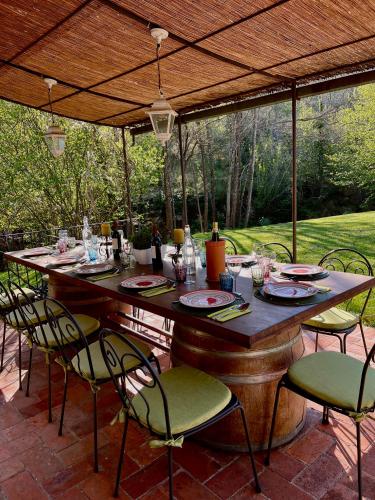 a table and chairs under an umbrella on a patio at Il Molinaccio in Gaiole in Chianti