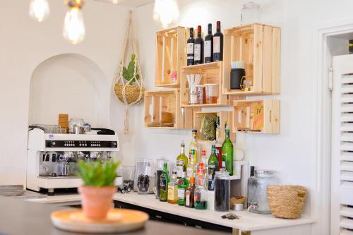 a kitchen with a counter with bottles on it at Single Fin Hotel & Lodge in Mimizan-Plage
