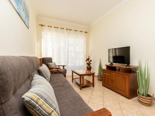 a living room with a couch and a flat screen tv at Akivillas Manta Rota Shell II in Manta Rota