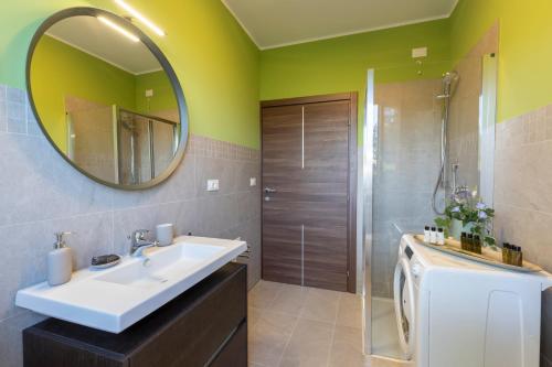 a bathroom with a sink and a mirror at DOLF - Villa Elisa - Intera Villa in Tolentino