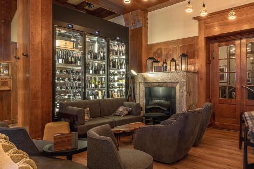 a living room with a couch and a fireplace at ALPINE INN Davos in Davos