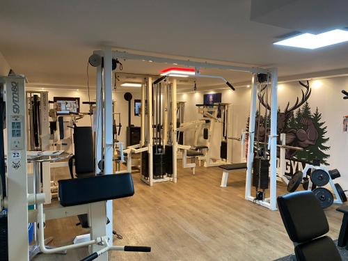 a gym with several tread machines in a room at Hotel Platzhirsch in Gaggenau
