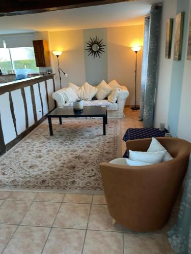 un salon avec un canapé et une table basse dans l'établissement Le Haouret, à Parleboscq