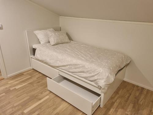 a small bedroom with a bed with a drawer at Orust East Coast Villa in Stillingsön