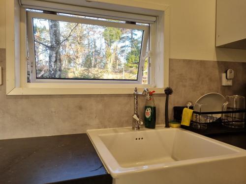 fregadero blanco en una cocina con ventana en Orust East Coast Villa, en Stillingsön