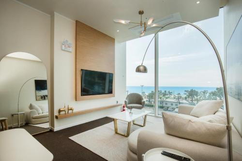 a living room with a view of the ocean at UH SUITE THE HAEUNDAE in Busan