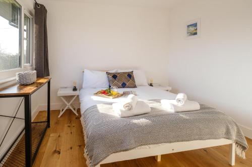 a bedroom with a bed with towels on it at Three Tuns - Garden Suite 1 in Wickham Market