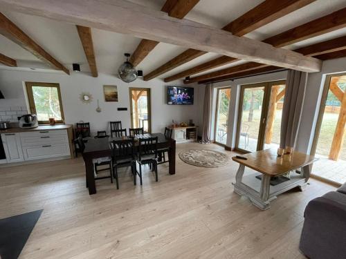 a kitchen and living room with a table and chairs at Country house in Dziemiany