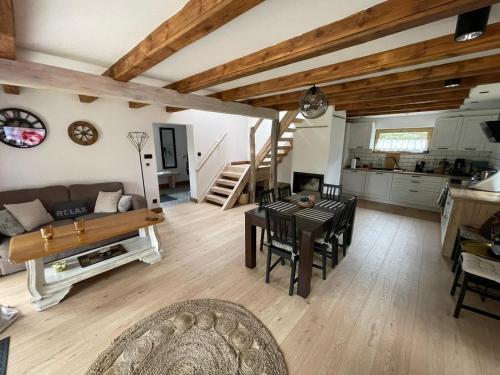 a living room with a couch and a table at Country house in Dziemiany